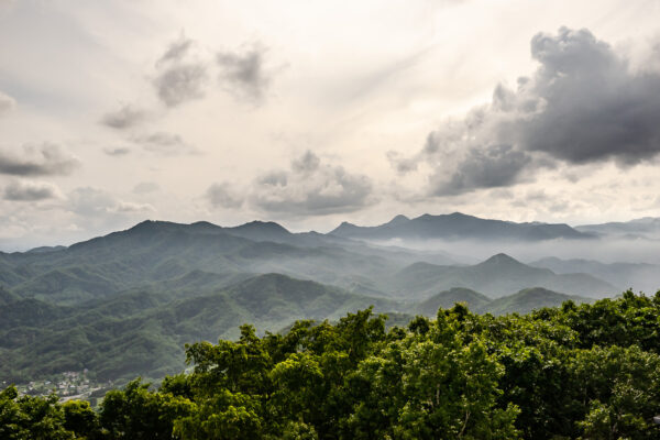 Fogs started to cover the mountain ridges observed from Mount Moiwa in Hokkaido, Japan. The observation deck has a 360 degree panoramatic view of the city of Sapporo, Mount Shokanbetsu, and the surrounding nature.